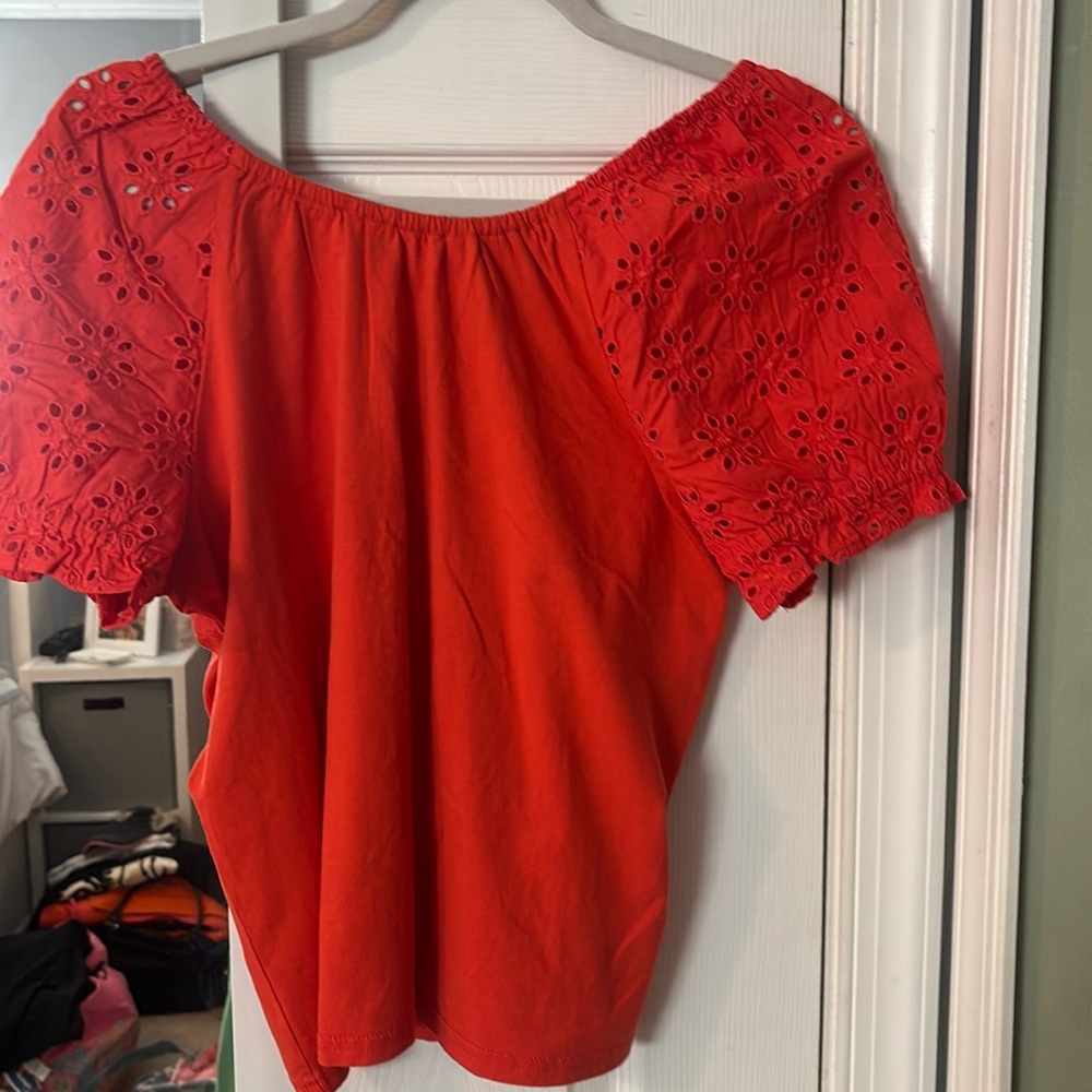 J Crew Top size Small! Orange with eyelet sleeves and bow on the back